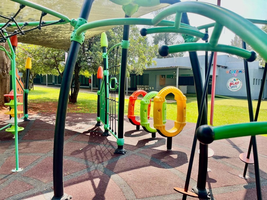 Climbing frame and play equipment under shade netting at The Play Date
