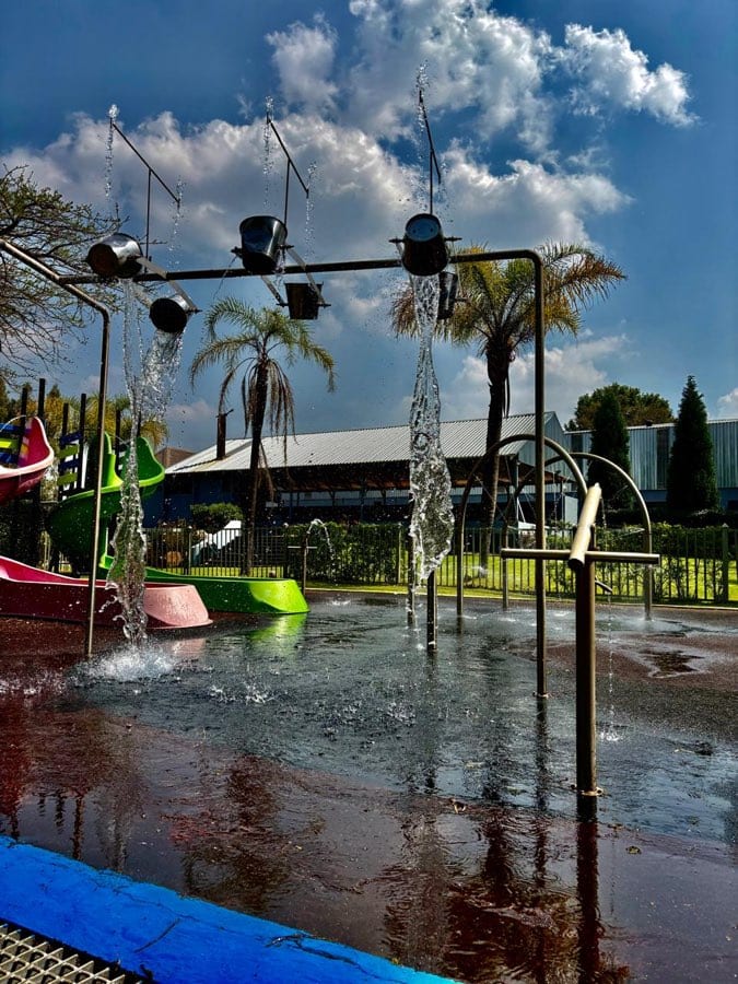 Tipping buckets and water jets splashing at The Play Date water park
